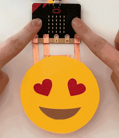 a heart eyed emoji animated with red LEDs underneath each heart